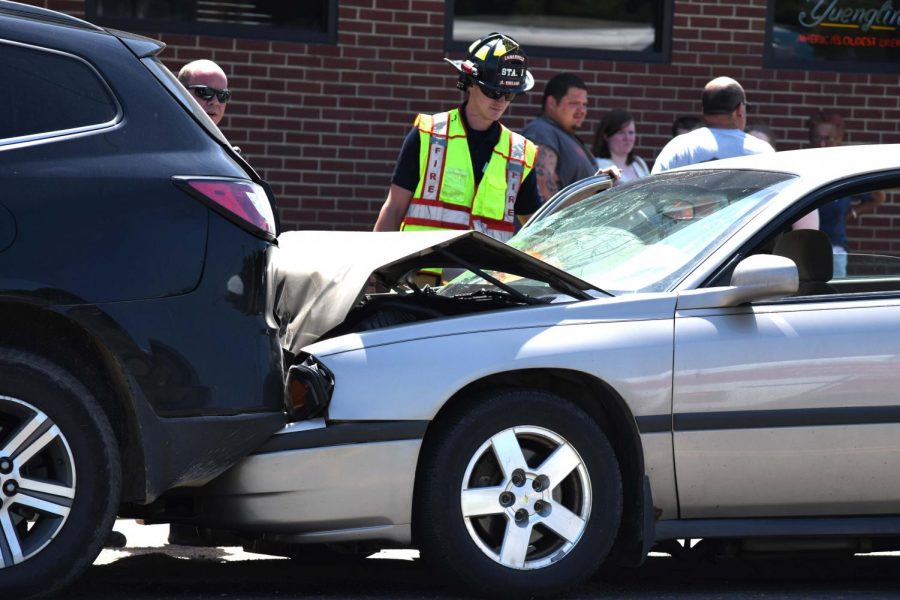 Emergency responders inspect vehicles following crash on Linden Avenue