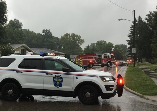 High water causes car to hydroplane into pole
