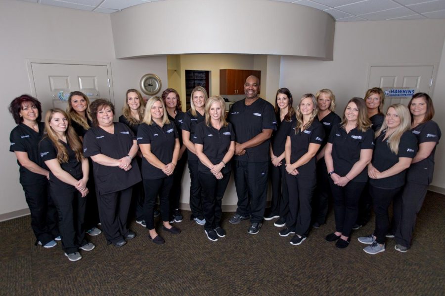 Dr.+Hawkins+poses+with+his+staff.+Photo+provided+by+Hawkins+Complete+Dental+Services.