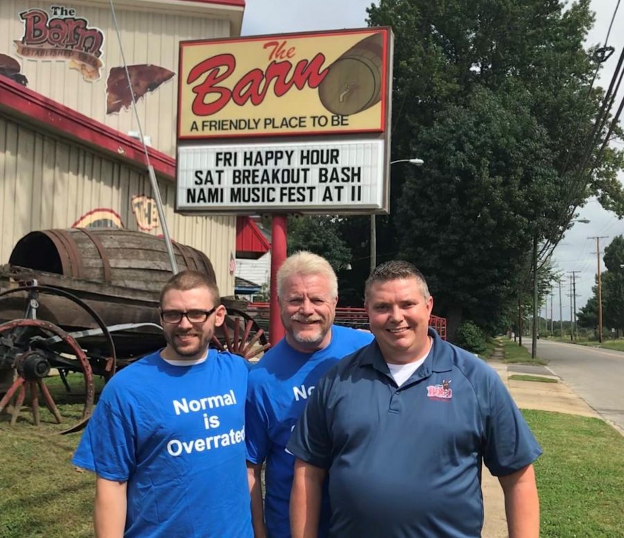 Anthony Hannan (left), Paul Quinn (middle) and Jim Watson (left) pose in front of The Barn sign that advertises the Breakout Bash happening Saturday. Photo provided by Paul Quinn before the 2018 Breakout Bash.