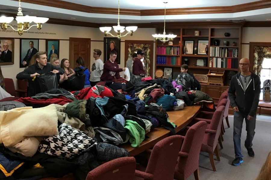 Donated coats from the 2017 annual coat drive are displayed on a large table. Photo provided by Christy Rahrig, Advisor with the Community Youth Foundation.