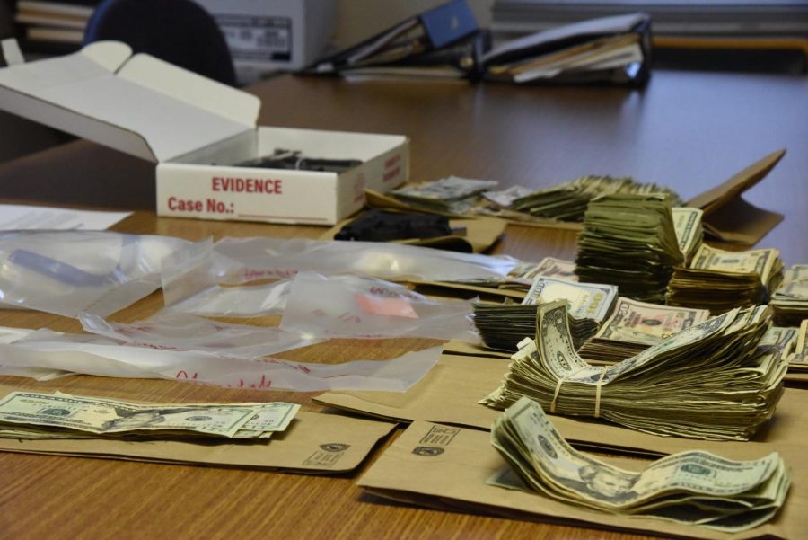 About $30,000 in cash, multiple substances and two hand guns are displayed as a result of a search warrant served on Norwood Boulevard Wednesday afternoon.