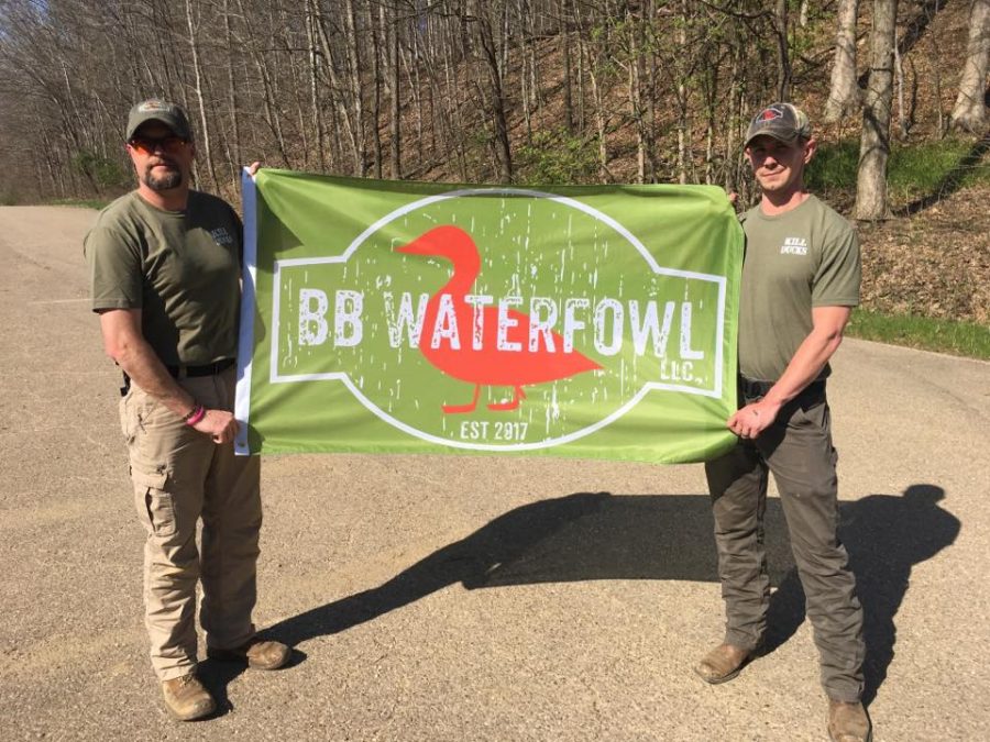 Bill Brooks, left, and Brandon Rexroad, right, hold out a BB Waterfowl sign with the companys logo. Photo provided by BB Waterfowl.