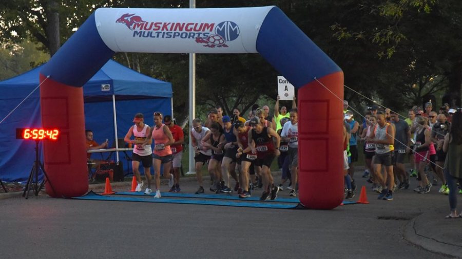 Runners take off from the starting point of the Zanesville City Half Marathon at Zanes Landing on Sept. 15, 2018.
