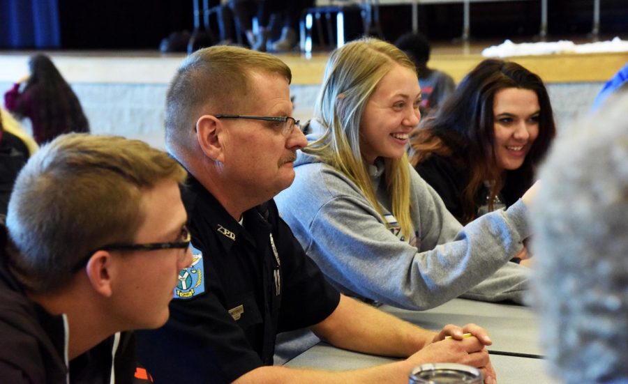Landerman sits at a table of high school students during their lunch period at Zanesville High School.