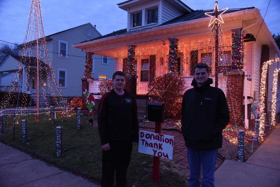Austin Lemmon (left) and Brandon Lemmon (right) stand in front of their light display. 