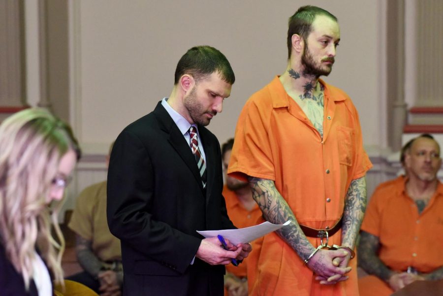 John A. Beatty (right) and his attorney Benjamin Whitacre (center) listen to Assistant Prosecuting Attorney Taylor Bennington (left) argue against a reduced bond for the defendant during Beatty's arraignment on Jan. 30.