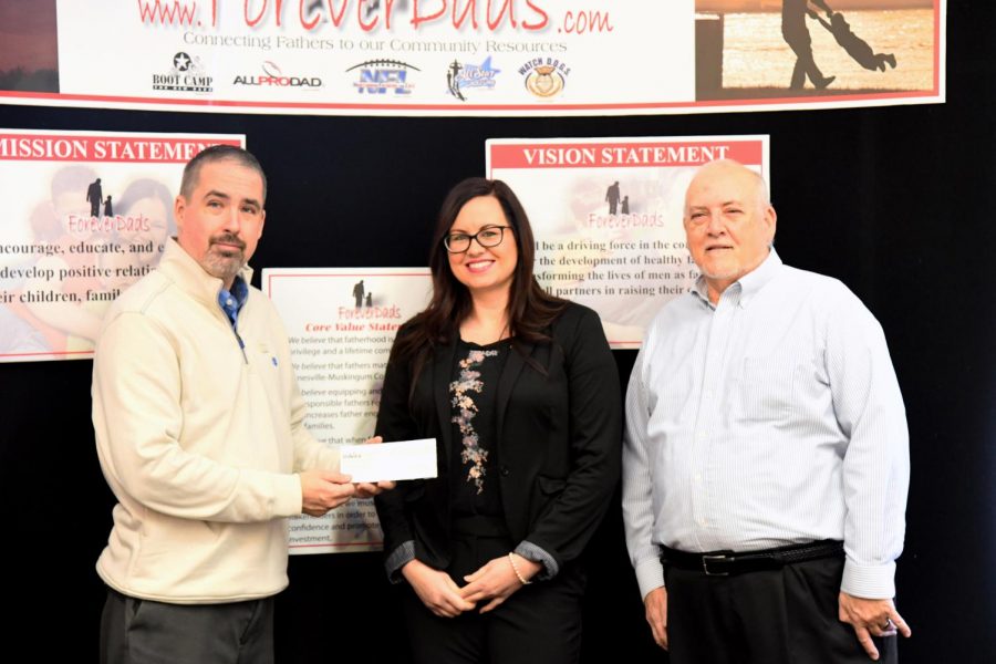 Michele Van Wey (center) presents a check for $950 to ForeverDads President, Jason Wilhelm (left) and ForeverDads Executive Director Burl Lemon (right).