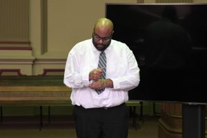 Defendant Anthony Colston unbuttons his sleeve at the prosecution's request in order to show the jury his tattoo for purposes of identification. 