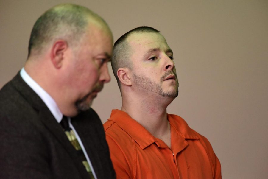 Dannie Devoll stands alongside his defense attorney Adam Sanderson to plea in the Muksingum County Court of Common Pleas Monday afternoon.