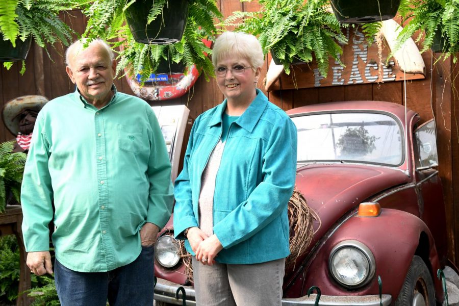 Danny Quinn (left) stands next to his wife Kristy Quinn (right) in the couples greenhouse thats attached directly to the Sunshine Shoppe.