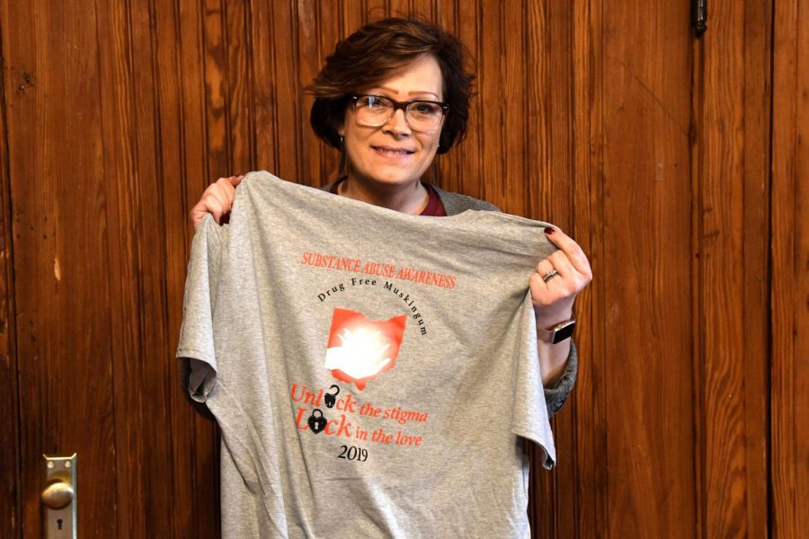 Monica Batteiger, one of the founders of Drug Free Muskingum, holds one of the organizations T-shirts for the Celebration of Life Walk.