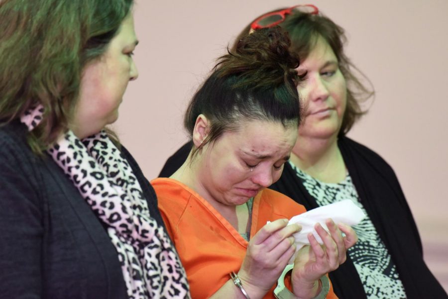 Samantha Donohoe wipes away tears as Judge Mark Fleegle reads her charges in Muskingum County Court of Common Pleas Monday. 