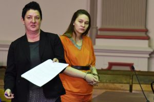 Megan Wilson's defense attorney, Nicole Churchill, shows the State the Tier II sex offender registration forms.