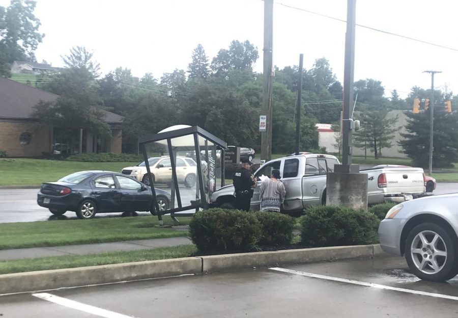 Driver crashes into bus shelter while clearing scene of accident