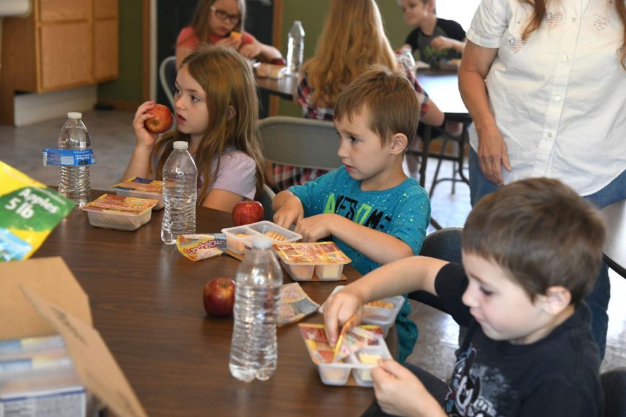 Kids dig into their Lunchables at the Eagle View Apartments office Monday afternoon. 