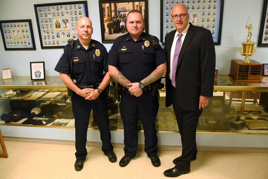 Newly promoted Sgt. Alan Etters (center) stands alongside Captain Scott Comstock (left) and Police Chief Tony Coury (right).