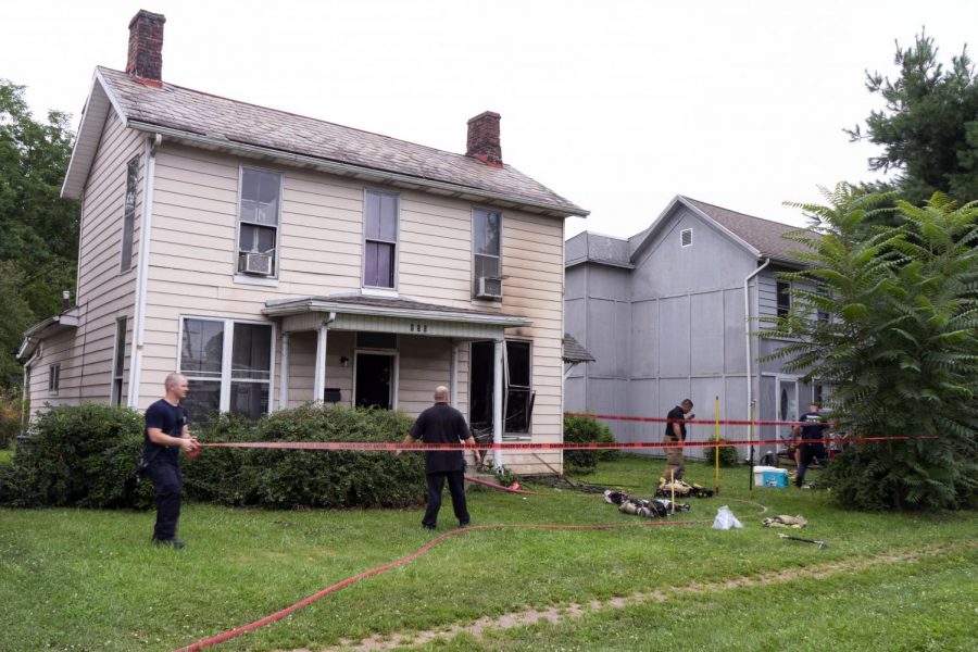 Firefighters tape off the property located at 950 Putnam Avenue after an electrical fire.