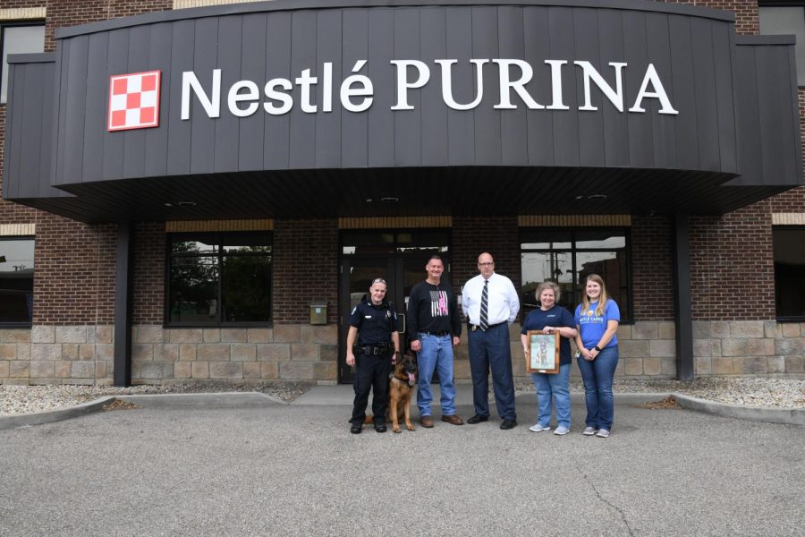 The Zanesville Police Department introduces its newest K-9 officer to the company that helped make his service possible.  Pictured left to right are Patrolman Brandon Hardesty, Plant Manager for Nestlé Purina Richard Driggs, ZPD Chief Tony Coury, Senior Coordinator at Nestlé Purina Rhonda Reed and HR Manager at Nestlé Purina Megan Baldus. 