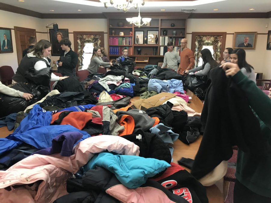 CYF members sorting through donated winter items at the conclusion of the 2018 CYF Winter Coat Drive | Photo provided by the Community Youth Foundation