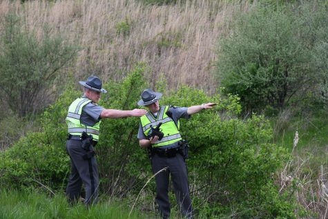 Trooper Nick Smith (right) helps analyze a fatal motorcycle accident near Trinway on April 29, 2019.