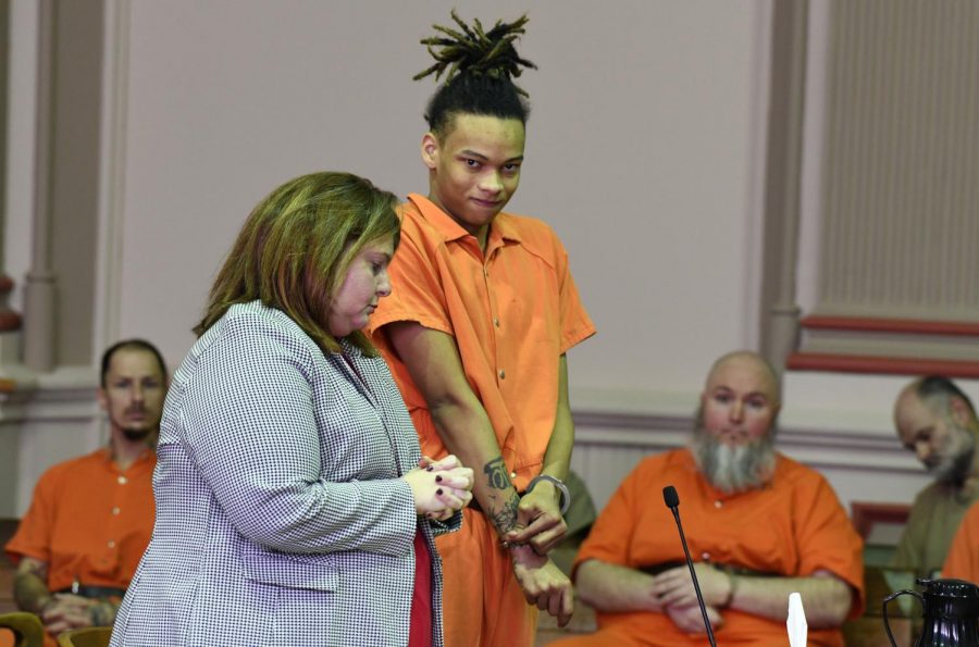 Jamal Mayle readjusts his handcuffs in court before being sentenced to 10 years in prison. 