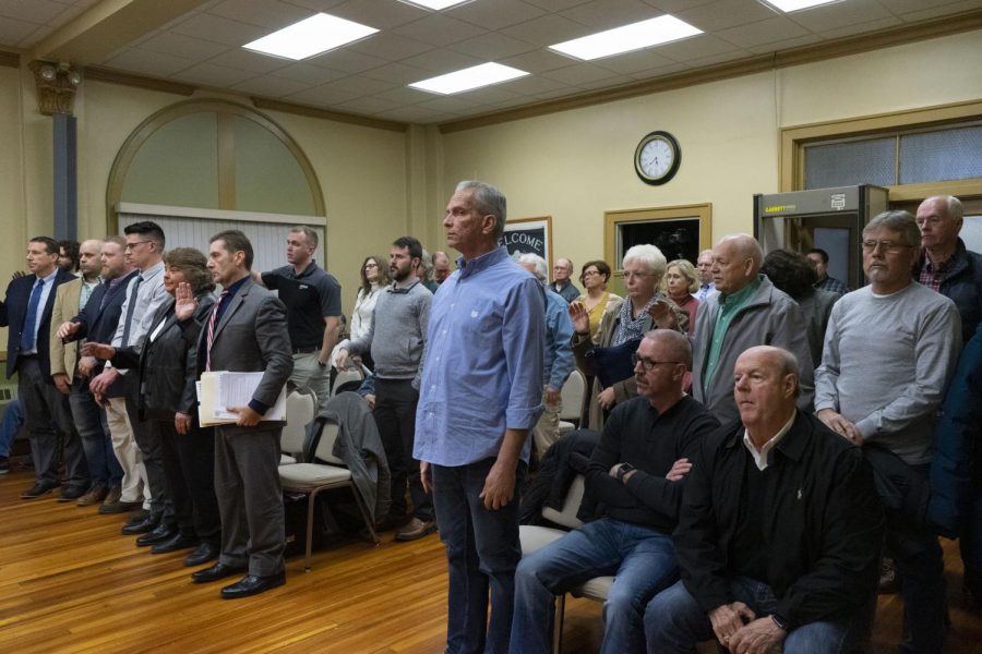 People in the audience of the Zanesville Board of Zoning Appeals who wished to speak during the meeting stand to take an oath.