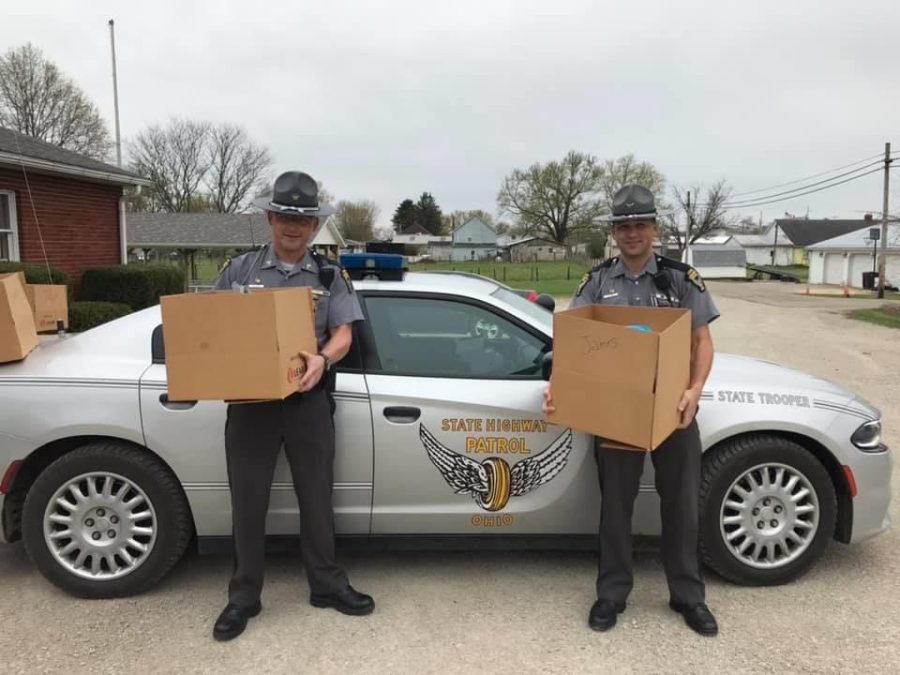 Sgt. Kyle Shirer (left) and Trooper Allen Shirer (right) preparing to hand out meals to students from Adamsville Elementary. 