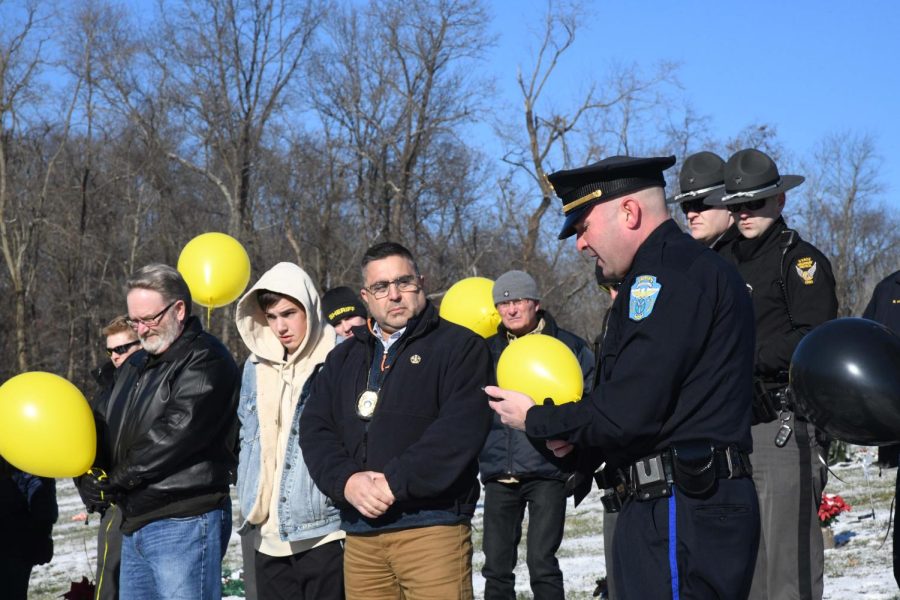 Detective Sergeant Phil Michel, President of FOZ Zane Lodge #5, reads a resolution recently passed by Muskingum County Commissioners dedicating a local bridge in the fallen officers honor during a ceremony held Saturday. 