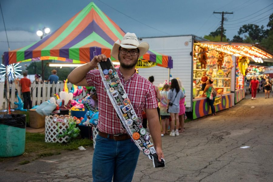 King Bradley Sheppard displays his sash covered with pins from fairs from across Ohio. 