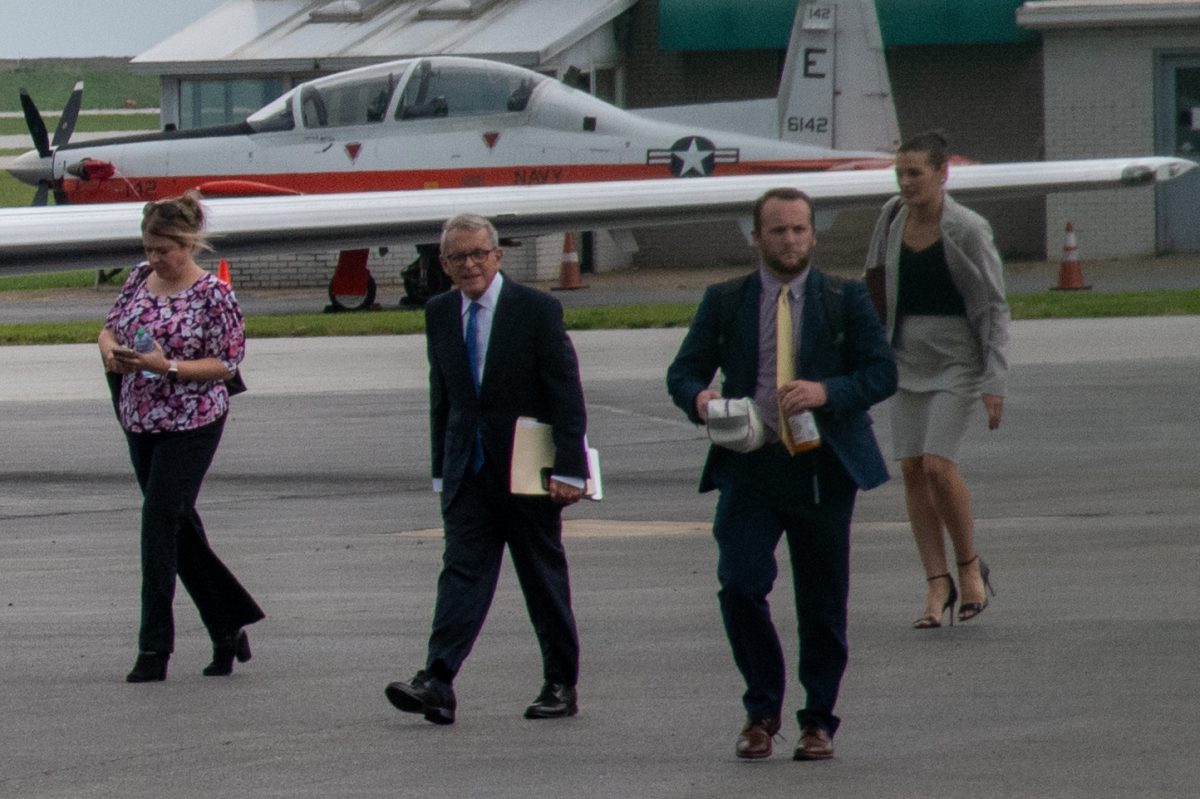 Gov. DeWine, along with others, walks to his plane to depart Cleveland earlier this month.