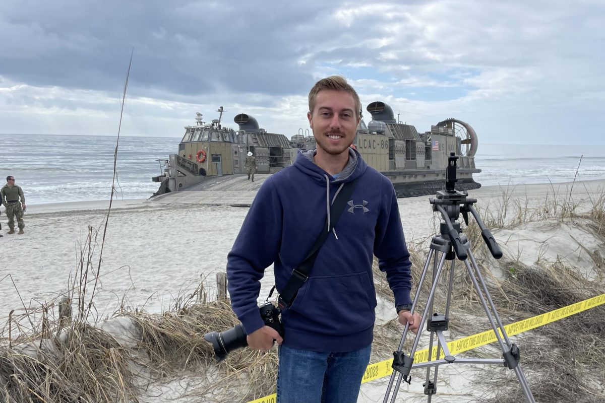 Y-City News Reporter Jason Schaumleffel in front of the Navys LCAC-86 in Cherry Grove Beach on February 9, 2023.