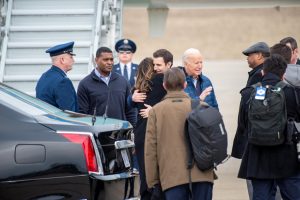 President Biden waves to the Press Pool while Pennsylvania Congressman Chris Deluzio embraces a women to his immediate left.